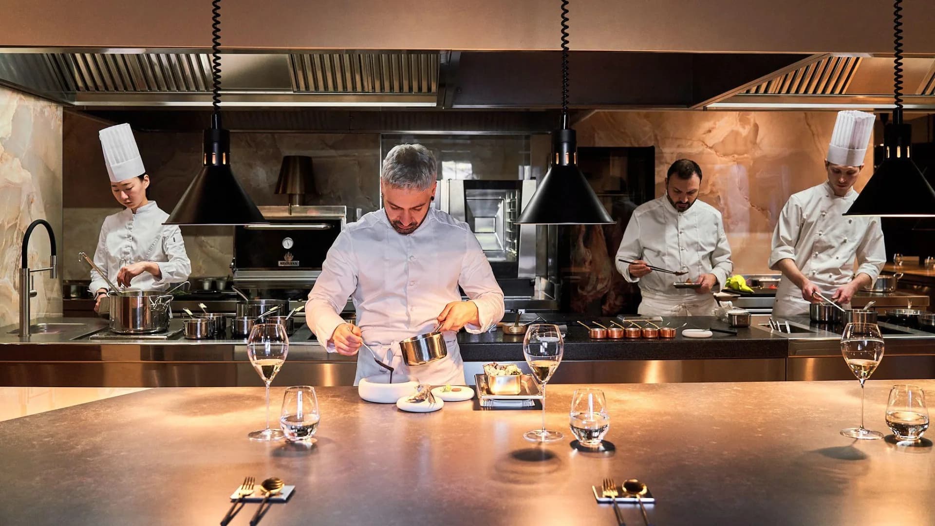 A team of professional chefs working during service in a restaurant kitchen